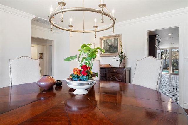 dining room featuring an inviting chandelier, crown molding, and visible vents