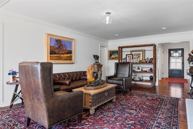 living area featuring crown molding, baseboards, and wood finished floors