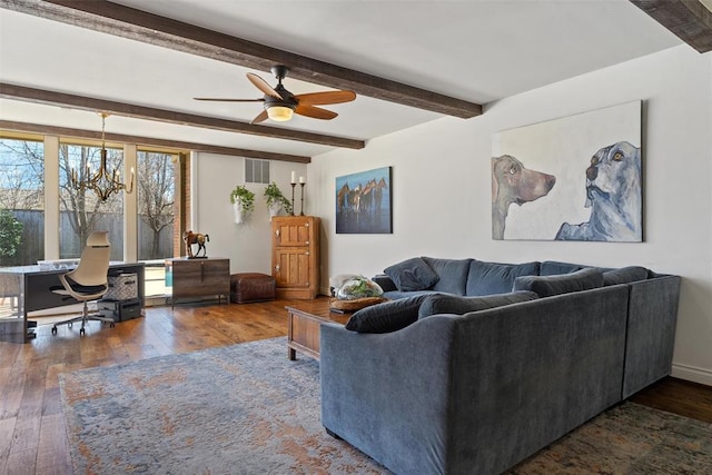 living area with hardwood / wood-style flooring, ceiling fan with notable chandelier, visible vents, and beam ceiling