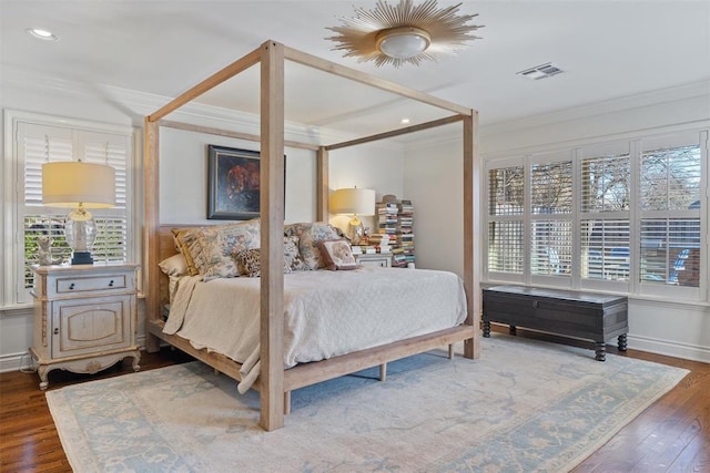 bedroom featuring wood finished floors, baseboards, visible vents, recessed lighting, and crown molding