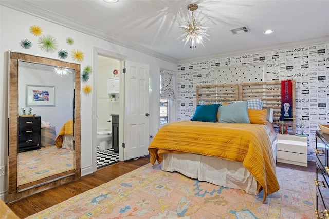 bedroom with wood finished floors, visible vents, ensuite bathroom, and ornamental molding