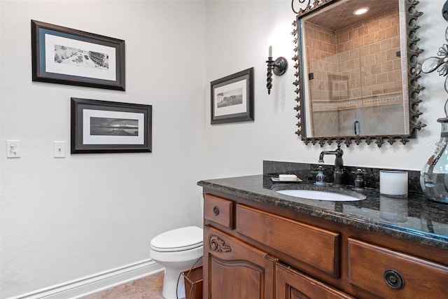 full bathroom featuring baseboards, toilet, vanity, and tile patterned flooring