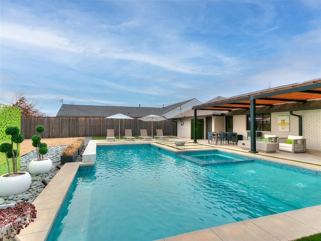 view of pool featuring a patio area, a pool with connected hot tub, and a fenced backyard