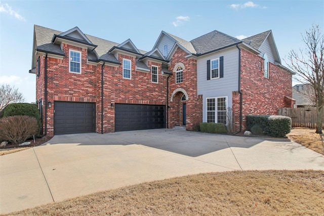 view of front of home featuring driveway, brick siding, and an attached garage