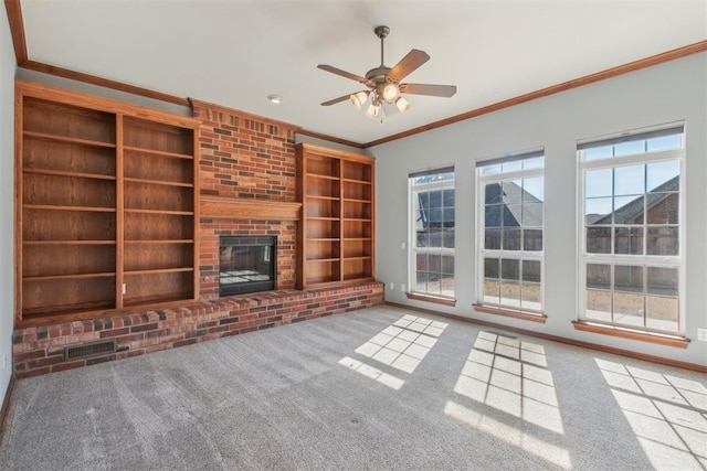 unfurnished living room with visible vents, built in features, light colored carpet, crown molding, and a brick fireplace