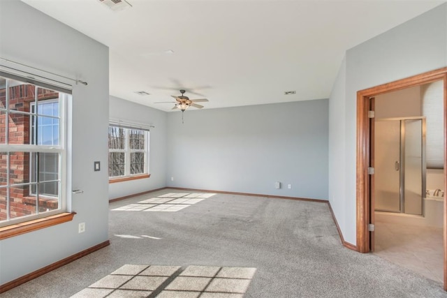 unfurnished room with light carpet, ceiling fan, visible vents, and baseboards