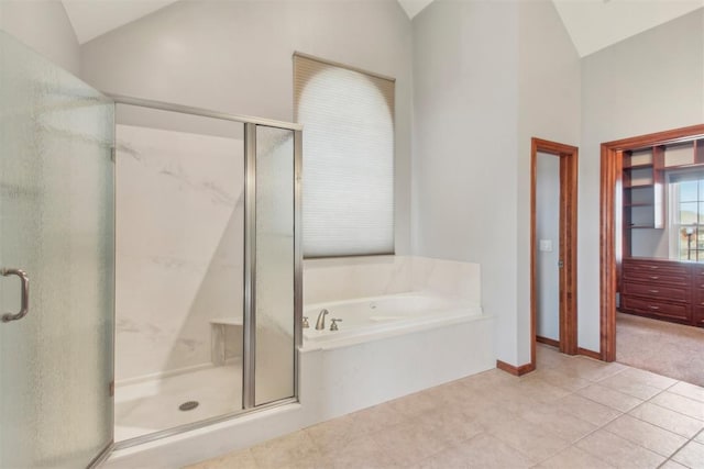 bathroom with lofted ceiling, a stall shower, tile patterned flooring, and a garden tub