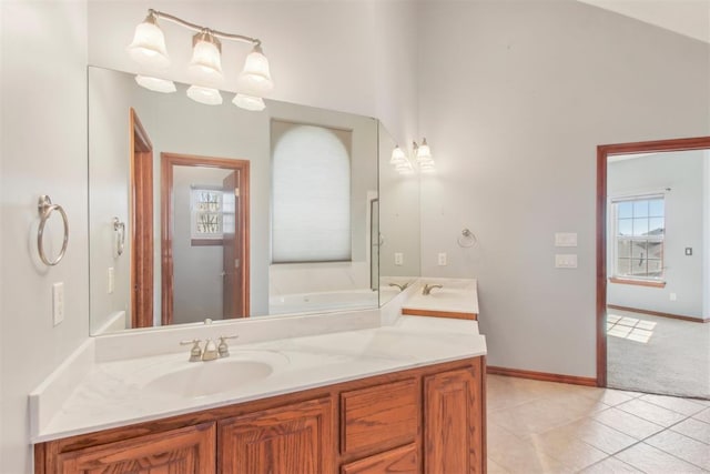 bathroom with baseboards, vanity, and tile patterned floors