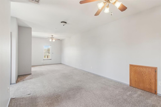 spare room featuring a ceiling fan and light carpet