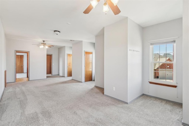 spare room featuring ceiling fan and light colored carpet