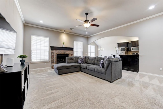 living room featuring arched walkways, light carpet, a fireplace, and baseboards