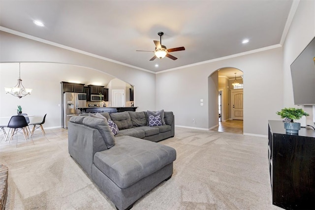 living room with light carpet, baseboards, arched walkways, and ornamental molding