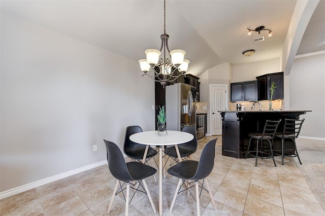 dining room with a chandelier, light tile patterned flooring, visible vents, and baseboards