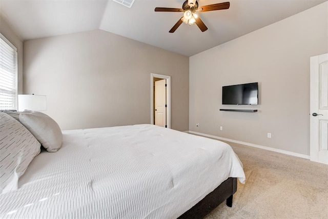 carpeted bedroom featuring vaulted ceiling, visible vents, a ceiling fan, and baseboards