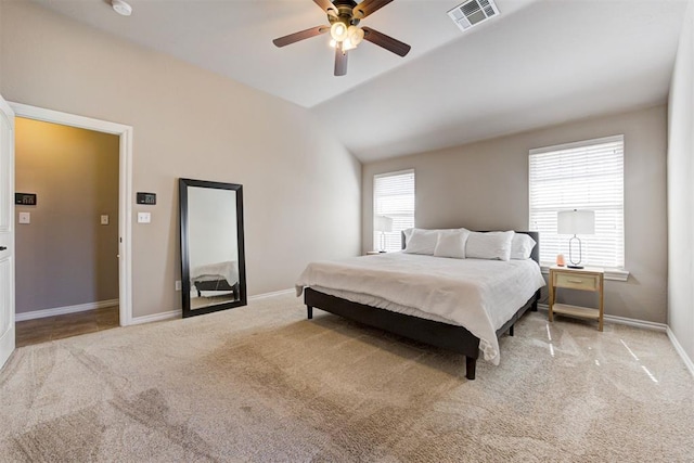 carpeted bedroom featuring baseboards, visible vents, and ceiling fan