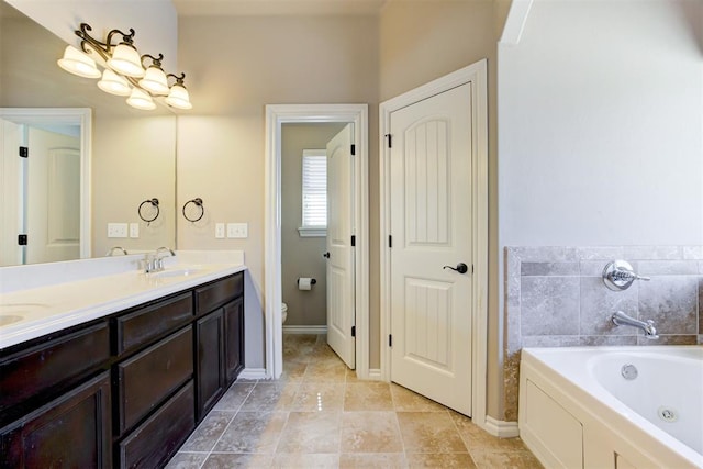 full bath with double vanity, toilet, a sink, tile patterned flooring, and a whirlpool tub