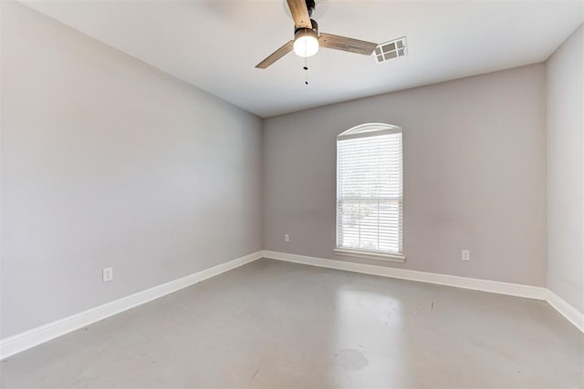 spare room featuring baseboards, ceiling fan, visible vents, and finished concrete floors