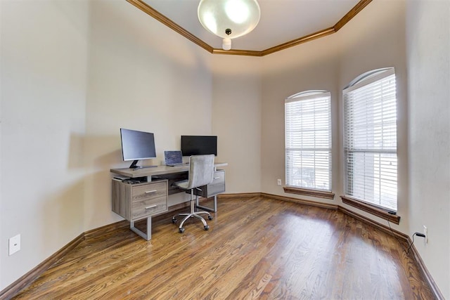 office space with baseboards, wood finished floors, and crown molding