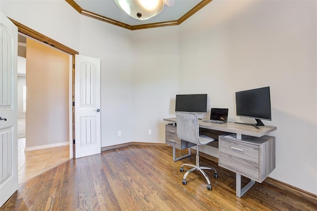 home office featuring baseboards, wood finished floors, and crown molding