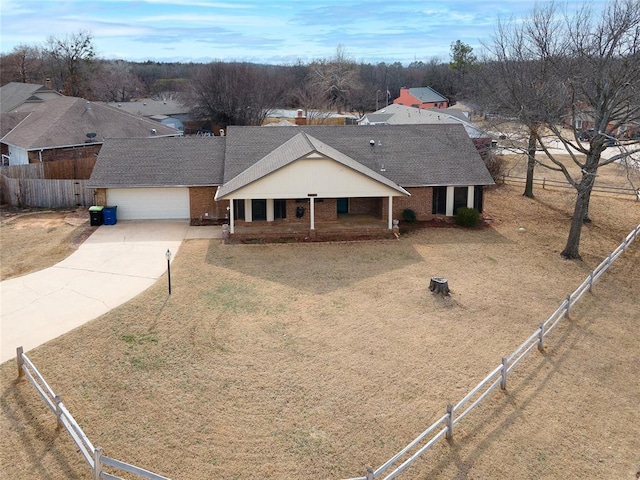 ranch-style home with fence, concrete driveway, and brick siding