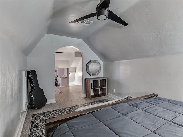 bedroom featuring visible vents, baseboards, carpet, lofted ceiling, and a ceiling fan