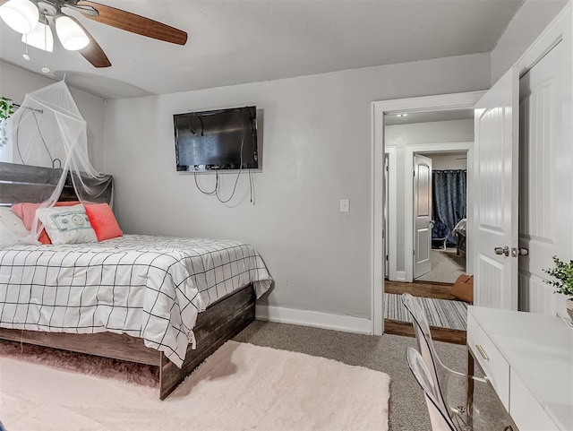 carpeted bedroom with a ceiling fan and baseboards