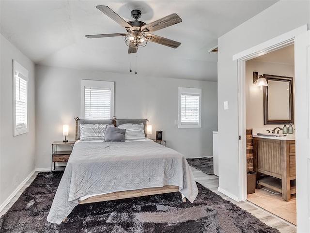 bedroom featuring baseboards, multiple windows, and a ceiling fan