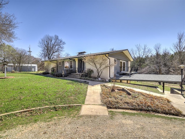 1802 N 15th St, Perry, OK 73077 - view of front facade featuring a front yard and brick siding
