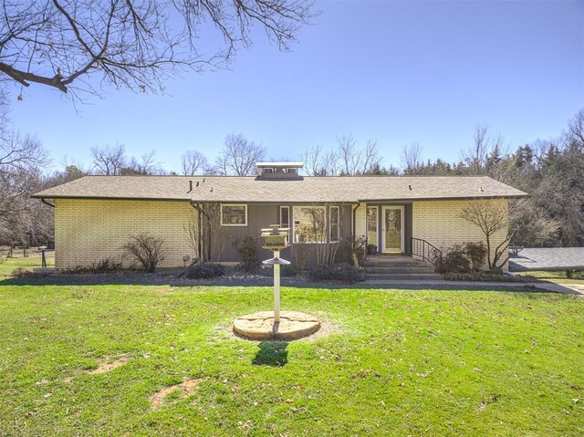 1802 N 15th St, Perry, OK 73077 - view of front facade with brick siding and a front lawn