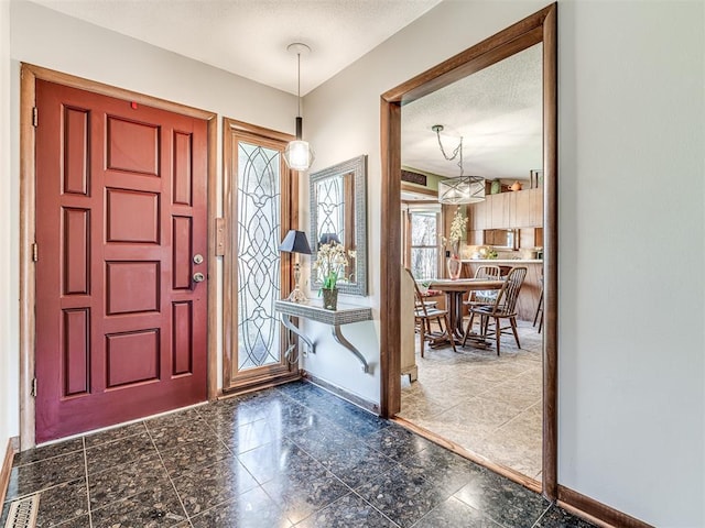 1802 N 15th St, Perry, OK 73077 - foyer entrance with baseboards and a textured ceiling