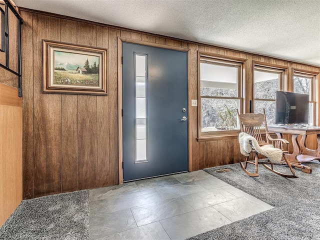 1802 N 15th St, Perry, OK 73077 - foyer with wood walls and a textured ceiling
