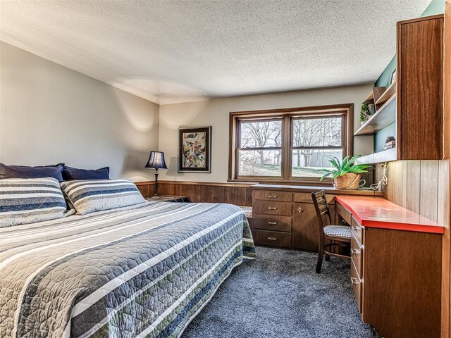 1802 N 15th St, Perry, OK 73077 - bedroom featuring dark carpet and a textured ceiling