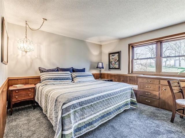 1802 N 15th St, Perry, OK 73077 - bedroom with carpet floors, a textured ceiling, wainscoting, and a chandelier