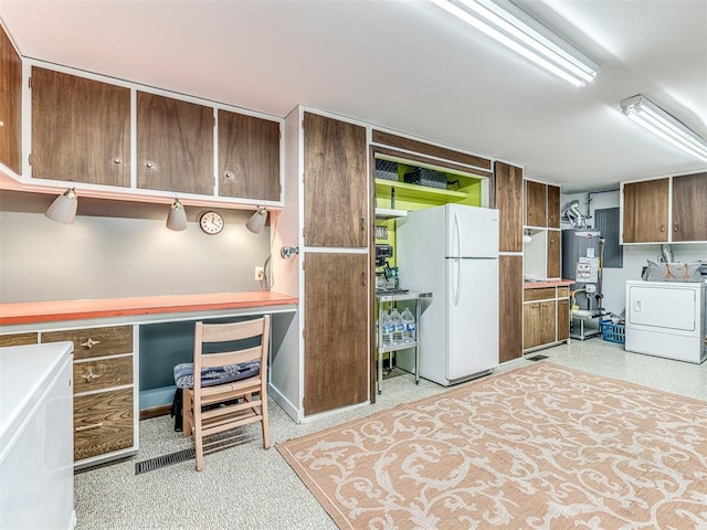 1802 N 15th St, Perry, OK 73077 - kitchen featuring freestanding refrigerator, washer / dryer, gas water heater, and an office area