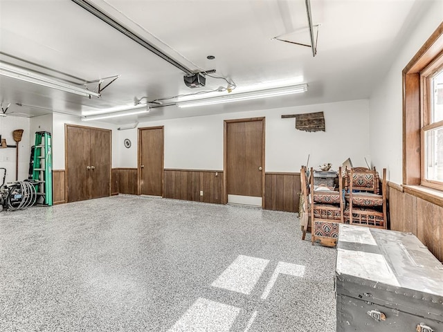 1802 N 15th St, Perry, OK 73077 - garage with wainscoting, wooden walls, and a garage door opener