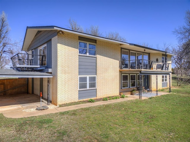 1802 N 15th St, Perry, OK 73077 - back of house with a balcony, brick siding, and a patio area