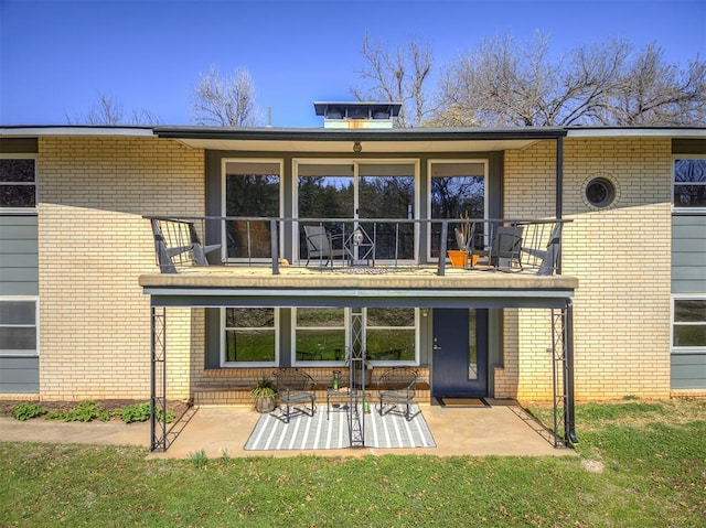 1802 N 15th St, Perry, OK 73077 - back of property featuring brick siding, a balcony, a patio, and a yard