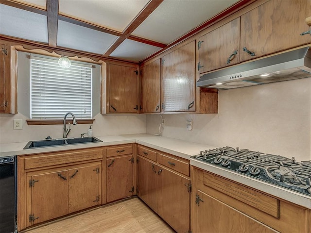 kitchen with dishwasher, light countertops, under cabinet range hood, stainless steel gas stovetop, and a sink