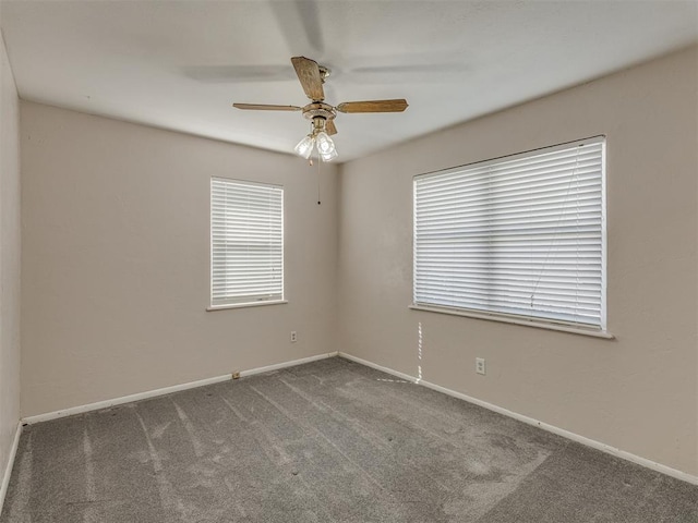 empty room featuring a ceiling fan, carpet, and baseboards