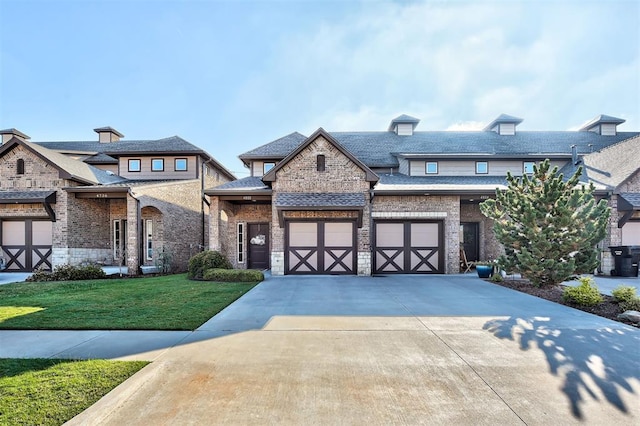 view of front of home with concrete driveway, brick siding, roof with shingles, and a front yard