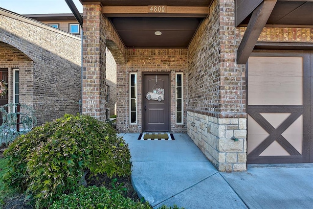 entrance to property with stone siding and brick siding