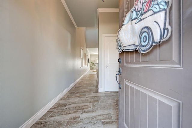 corridor featuring ornamental molding and baseboards