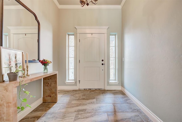 foyer entrance with plenty of natural light, baseboards, and crown molding