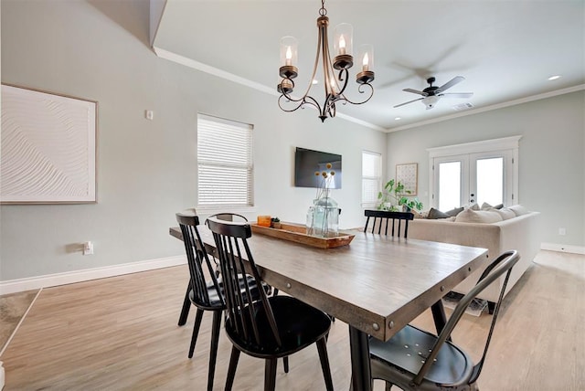 dining space with baseboards, visible vents, ornamental molding, french doors, and light wood-type flooring