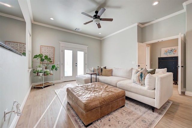 living area with french doors, visible vents, light wood-style flooring, and baseboards