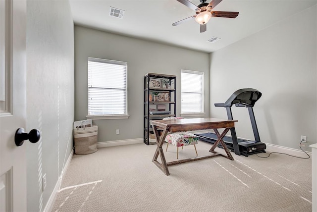 office with light carpet, a healthy amount of sunlight, and visible vents