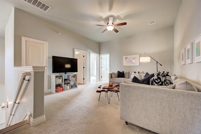 living area with light carpet, baseboards, visible vents, and a ceiling fan