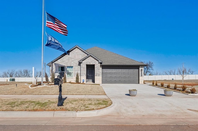 view of front of house with concrete driveway, a shingled roof, an attached garage, and brick siding