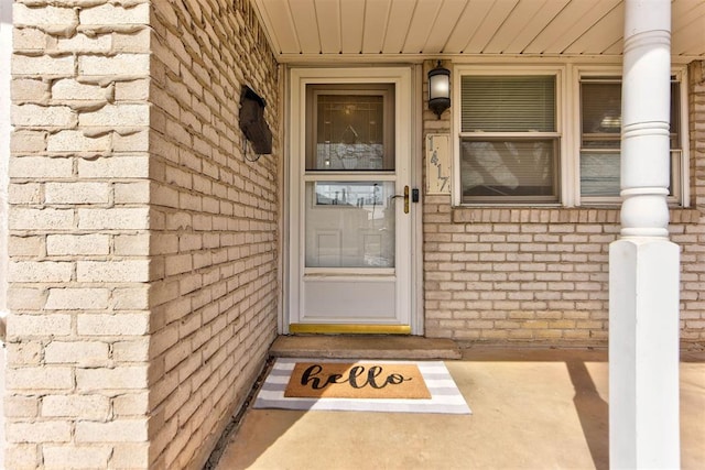 property entrance with brick siding