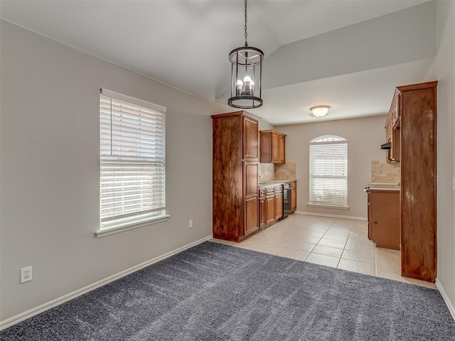 kitchen with light carpet, hanging light fixtures, vaulted ceiling, and backsplash